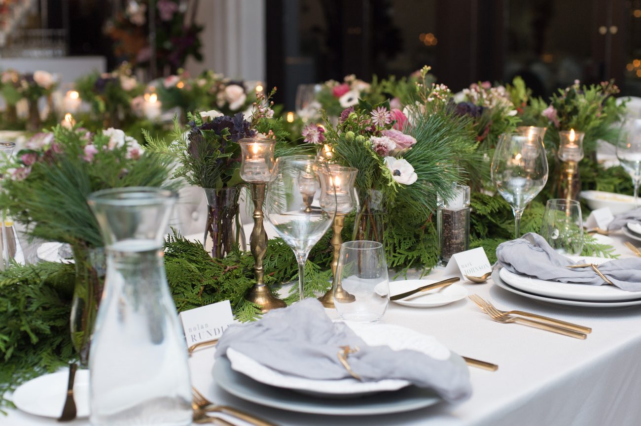 holiday party centrepieces with pines and gold accents