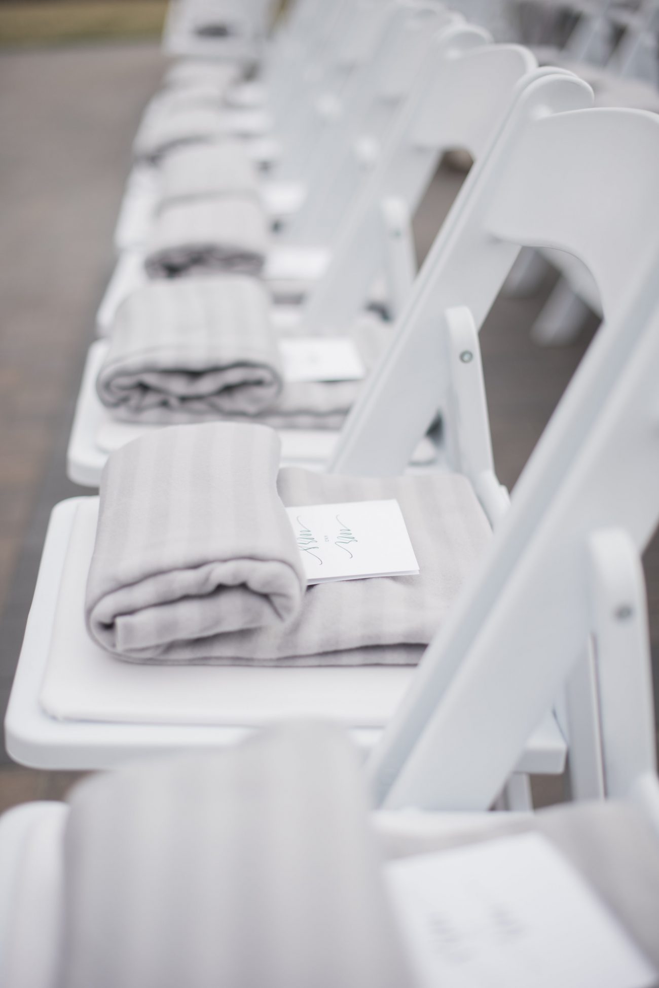 shawls provided on chairs for outdoor wedding event