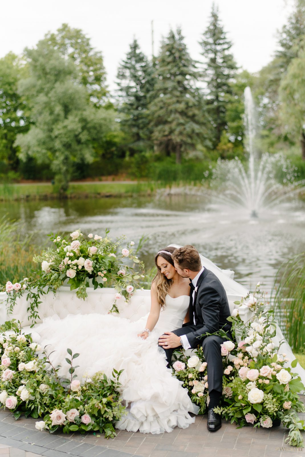 Newlywed posing by the pond